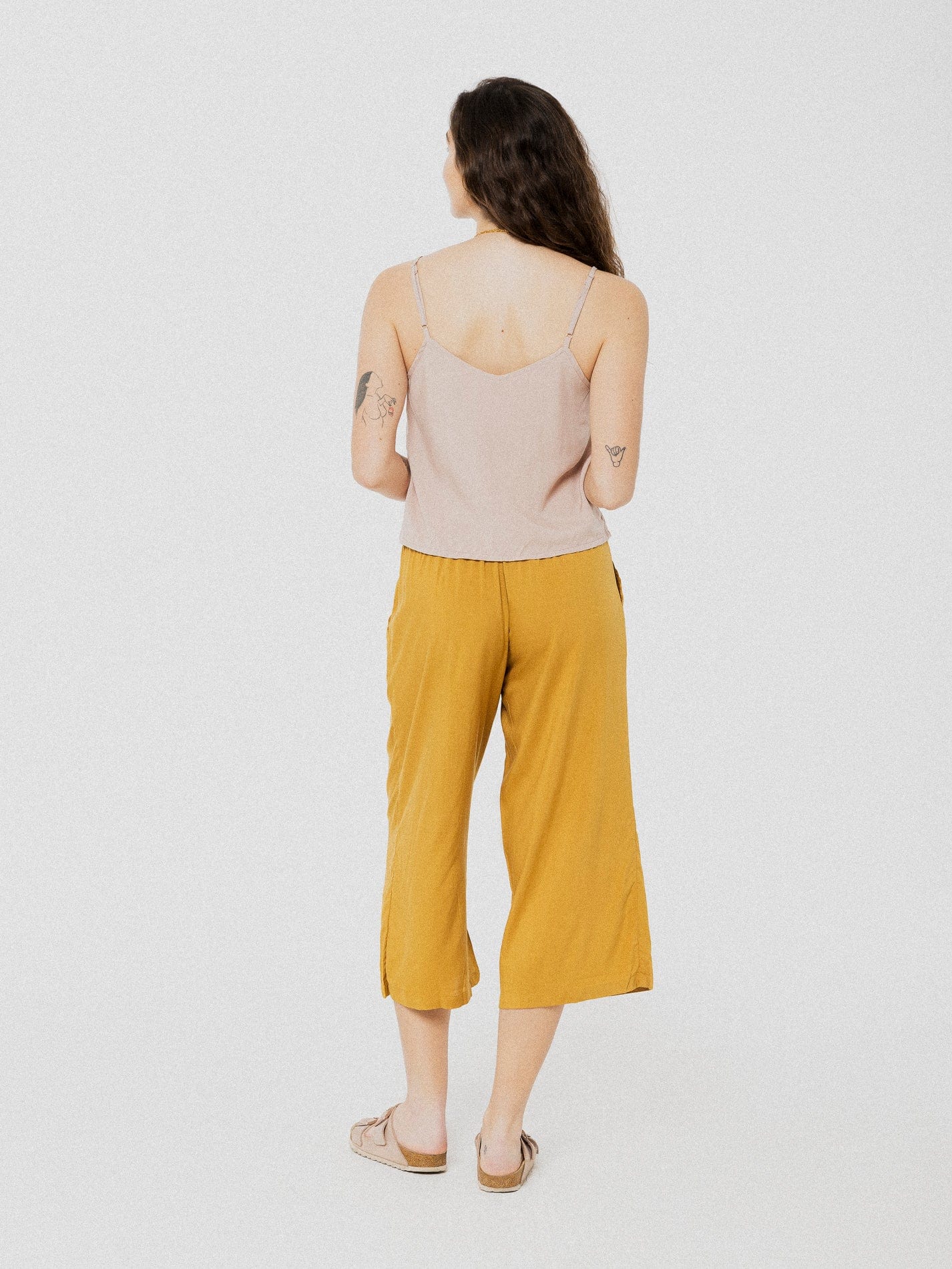 Pantalon 3/4 ample et confortable doré avec ceinture en tissu à la taille.